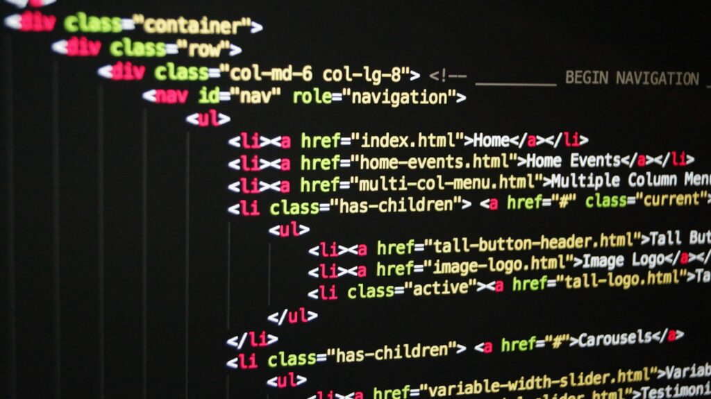 pexels-pixabay-270404 Close-up of vibrant HTML code displayed on a computer screen, showcasing web development and programming.